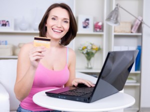 Smiling Woman Using Credit Card With Low Interest Rates