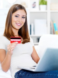 Happy Woman Uses Deals Credit Cards To Get Online Bargains